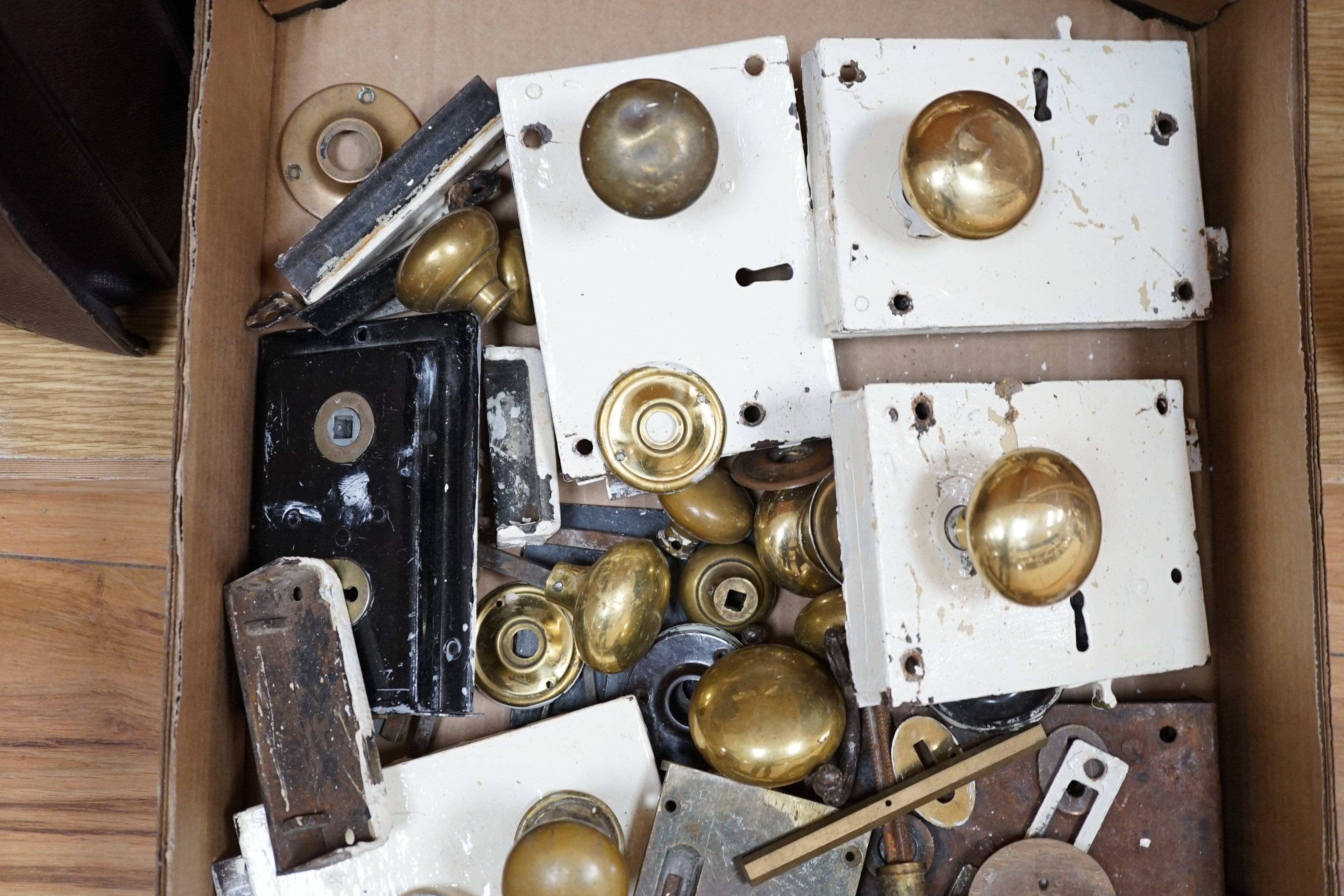 A collection of door locks and brass knobs